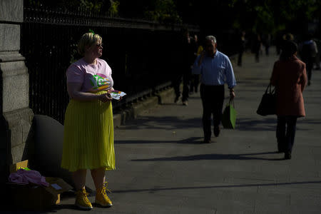 A Pro-Choice volunteer waits to hand out leaflets on the street ahead of a 25th May referendum on abortion law, in Dublin, Ireland May 22, 2018. REUTERS/Clodagh Kilcoyne