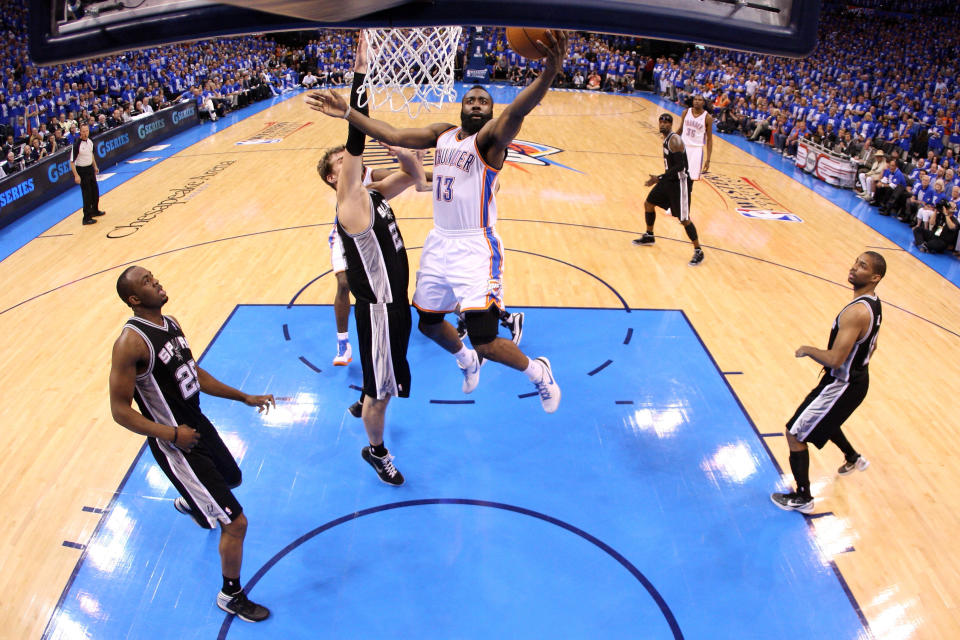 OKLAHOMA CITY, OK - MAY 31: James Harden #13 of the Oklahoma City Thunder goes up for a shot against Tiago Splitter #22 of the San Antonio Spurs in Game Five of the Western Conference Finals of the 2012 NBA Playoffs at Chesapeake Energy Arena on May 31, 2012 in Oklahoma City, Oklahoma. NOTE TO USER: User expressly acknowledges and agrees that, by downloading and or using this photograph, User is consenting to the terms and conditions of the Getty Images License Agreement. (Photo by Ronald Martinez/Getty Images)