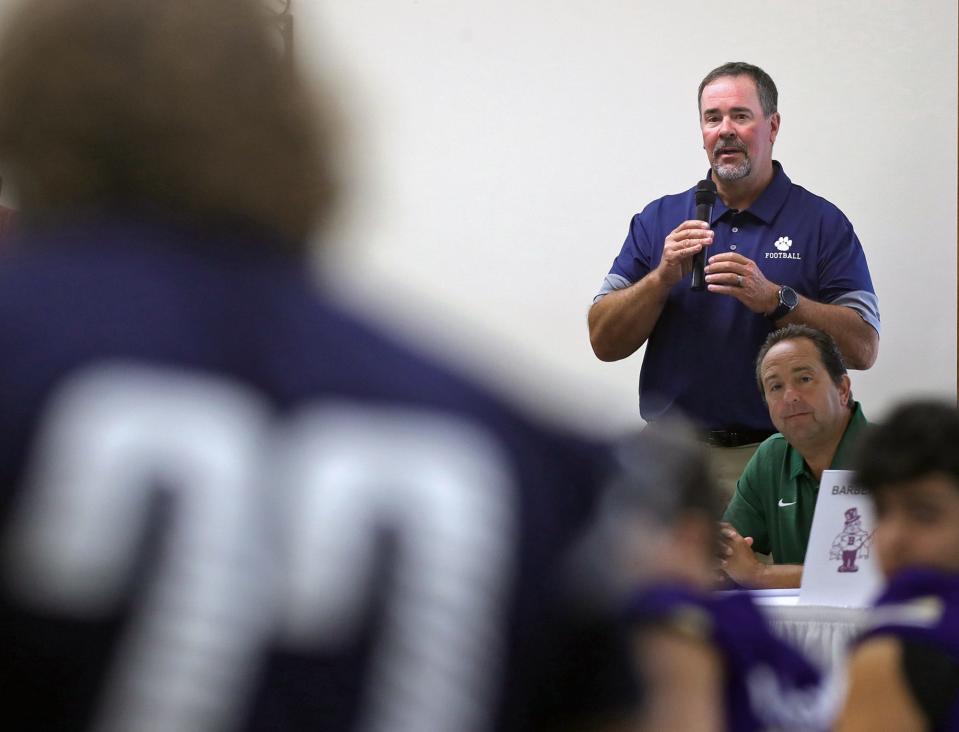 Twinsburg football coach Mike Bell, seen here introducing his players during the Suburban League luncheon in July, has announced his resignation as the Tigers' varsity football coach.