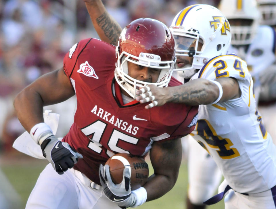 Arkansas tight end D.J. Williams (45) tries to elude Tennessee Tech defensive back Will Johnson (24) during the second quarter of an NCAA college football game in Fayetteville, Ark., Saturday, Sept. 4, 2010. (AP Photo/April L Brown)