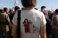 Protesters gather in support of Mahsa Amini, an Iranian Kurdish woman after she was arrested in Tehran by morality police for wearing her headscarf improperly, outside the UN headquarters on Sept. 24, 2022, in Erbil. Iran has accused Kurdish opposition groups in exile of orchestrating the wave of protests across the country over the past two weeks. But Kurdish activists say the government is just trying to scapegoat them to distract from the domestic anger fueling the unrest.(AP Photo/Hawre Khalid, Metrography)