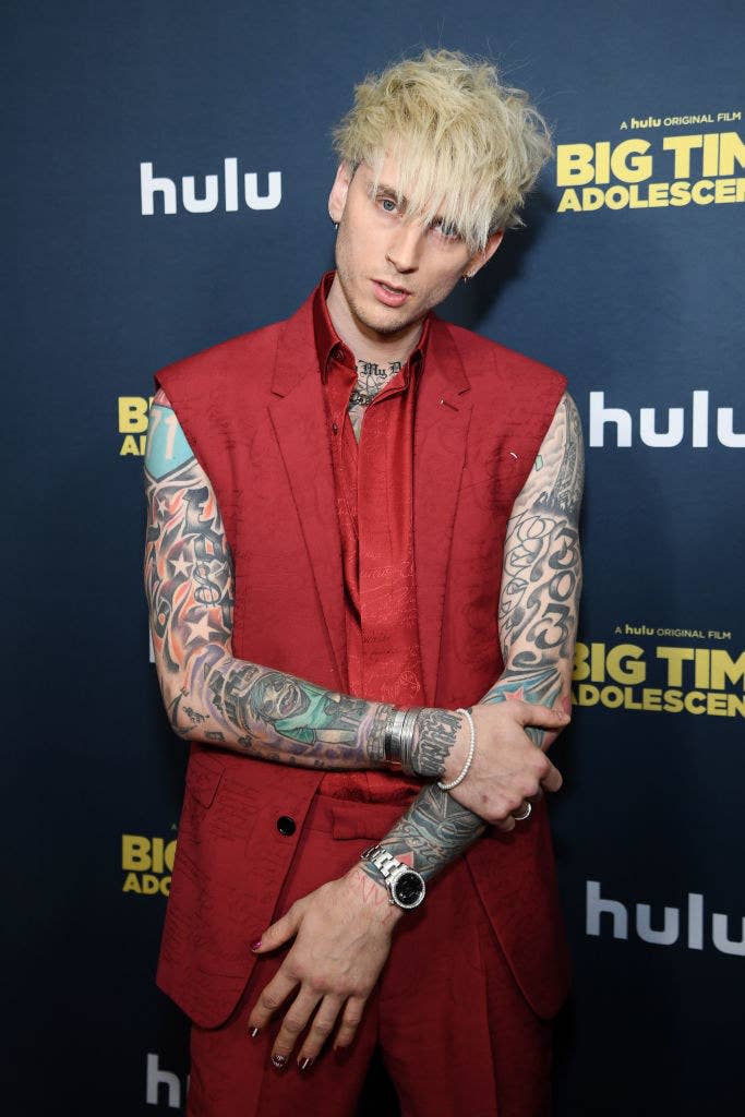 MGK posing for photographers on the red carpet at a movie premiere