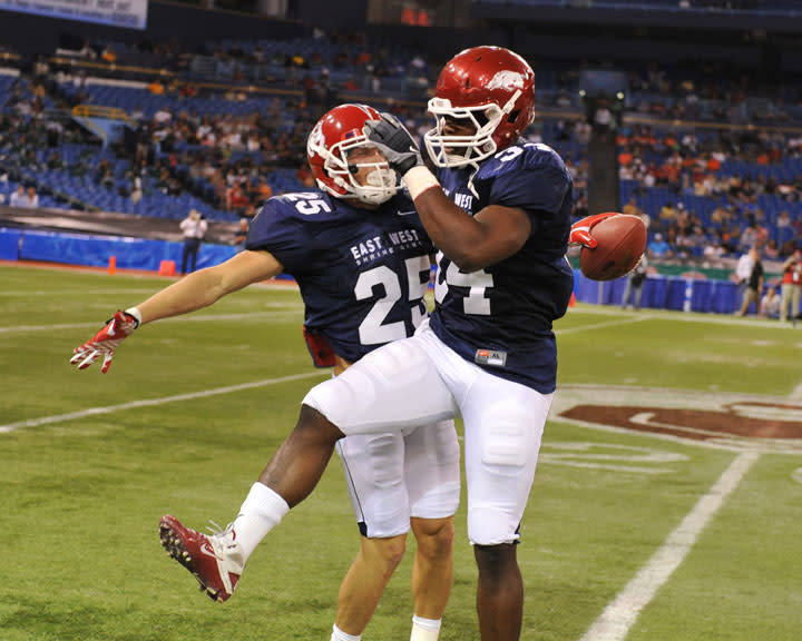 ST. PETERSBURG, FL - JANUARY 21: Wide receiver Devon Wylie #25 of the Fresno State University Bulldogs celebrates a kick return with linebacker Jerry Franklin #34 of the University of Arkansas Razorbacks during the 87th annual East-West Shrine game January 21, 2012 at Tropicana Field in St. Petersburg, Florida. (Photo by Al Messerschmidt/Getty Images)
