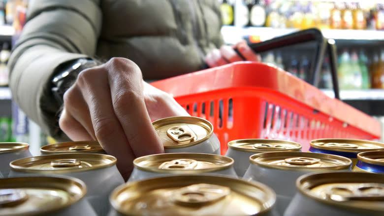 A person shopping for canned coffee