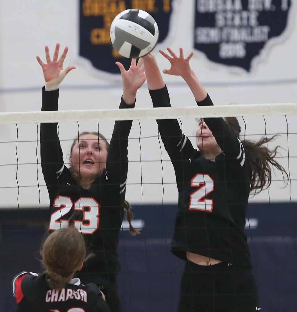 Kylie Gorsuch, left, and Mia Schindewolf of Green block a hit by Annabel Frieden of Chardon during the second set of their Division I volleyball district semifinal match at Solon High School in Solon on Tuesday night. Chardon advanced in tournament 3-1.