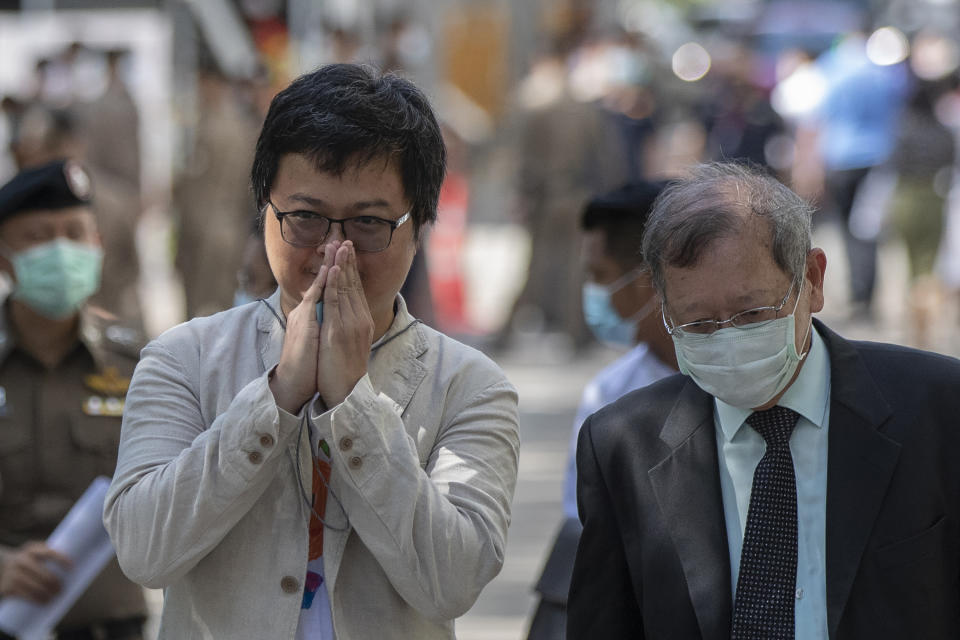 FILE- In this Sept. 3, 2020, file photo, pro-democracy activist and human rights lawyer Arnon Nampha, left, greets as he arrives at criminal courthouse for hearing to determine whether he has violated his bail conditions in Bangkok, Thailand. Nampha and Panupong Jadnok, two top leaders of Thailand's pro-democracy protest movement, were released from jail Monday, Sept. 7, 2020 after police agreed they no longer needed to be detained for investigation. (AP Photo/Gemunu Amarasinghe, File)