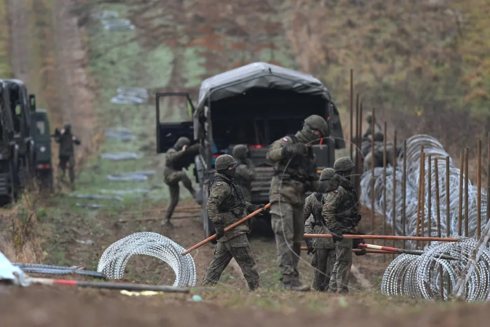 FILE - Polish soldiers begin laying a razor wire barrier along Poland's border with the Russian exclave of Kaliningrad in Wisztyniec, Poland, on Wednesday Nov. 2, 2022. At the beginning of November 2022, Polish soldiers began laying coils of razor wire on the border with Kaliningrad, a Russian region wedged between Poland and Lithuania. (AP Photo/Michal Kosc, File)