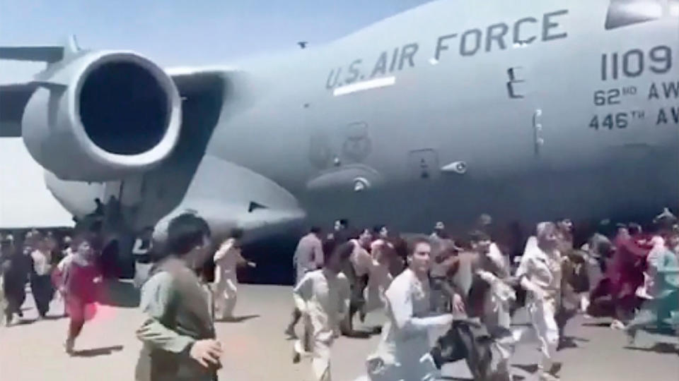 Seen here, Afghanistan civilians run alongside the US aircraft as it evacuates people from the country. 