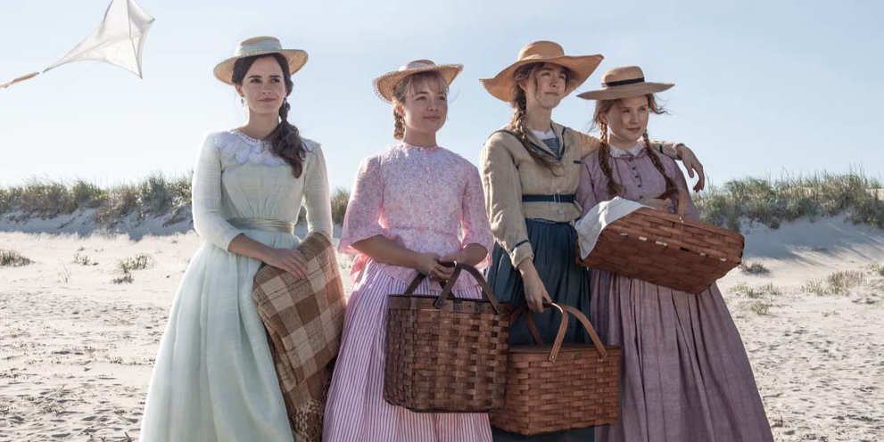 from left to right, emma watson, florence pugh, saoirse ronan, and eliza scanlen, four white actresses, in a still from little women where they are standing on a beach in 1800s clothing