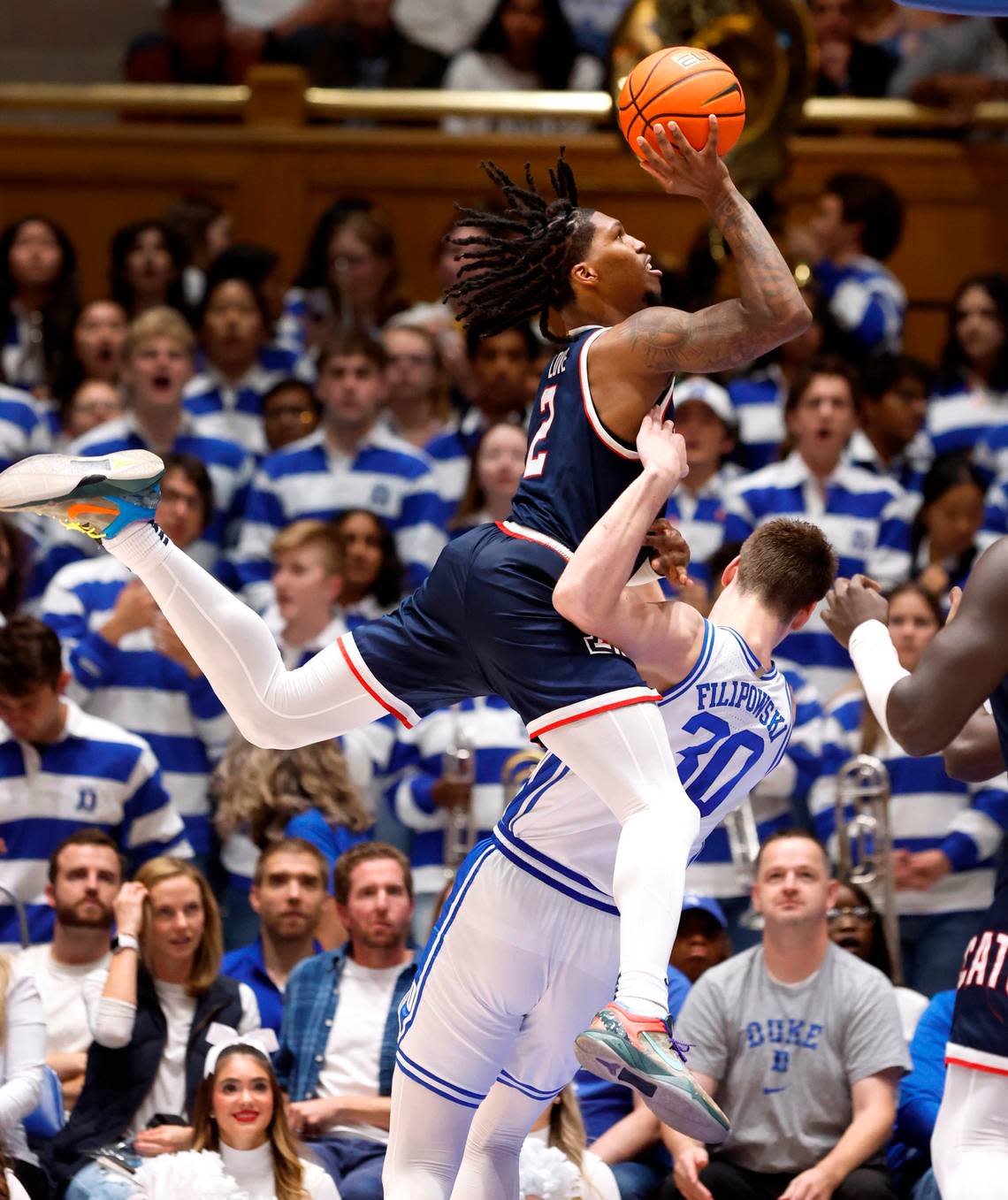 Duke’s Kyle Filipowski (30) draws the foul as Arizona’s Caleb Love (2) drives to the basket during the second half of Arizona’s 78-73 victory over Duke at Cameron Indoor Stadium in Durham, N.C., Friday, Nov. 10, 2023.