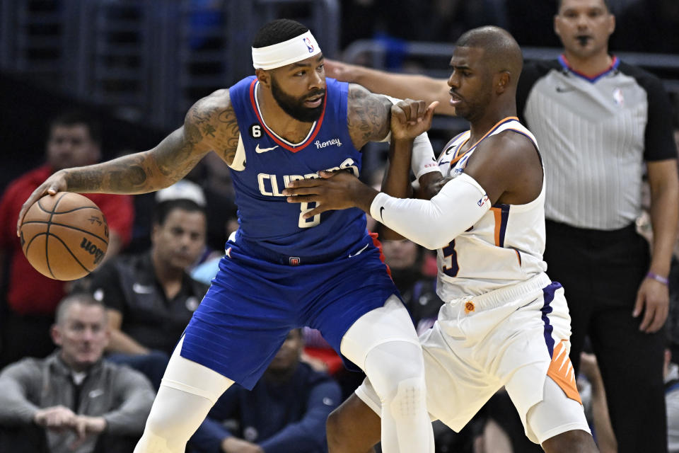 Los Angeles Clippers forward Marcus Morris Sr., left, drives into Phoenix Suns guard Chris Paul during the first half of an NBA basketball game, Sunday, Oct. 23, 2022, in Los Angeles. (AP Photo/Alex Gallardo)