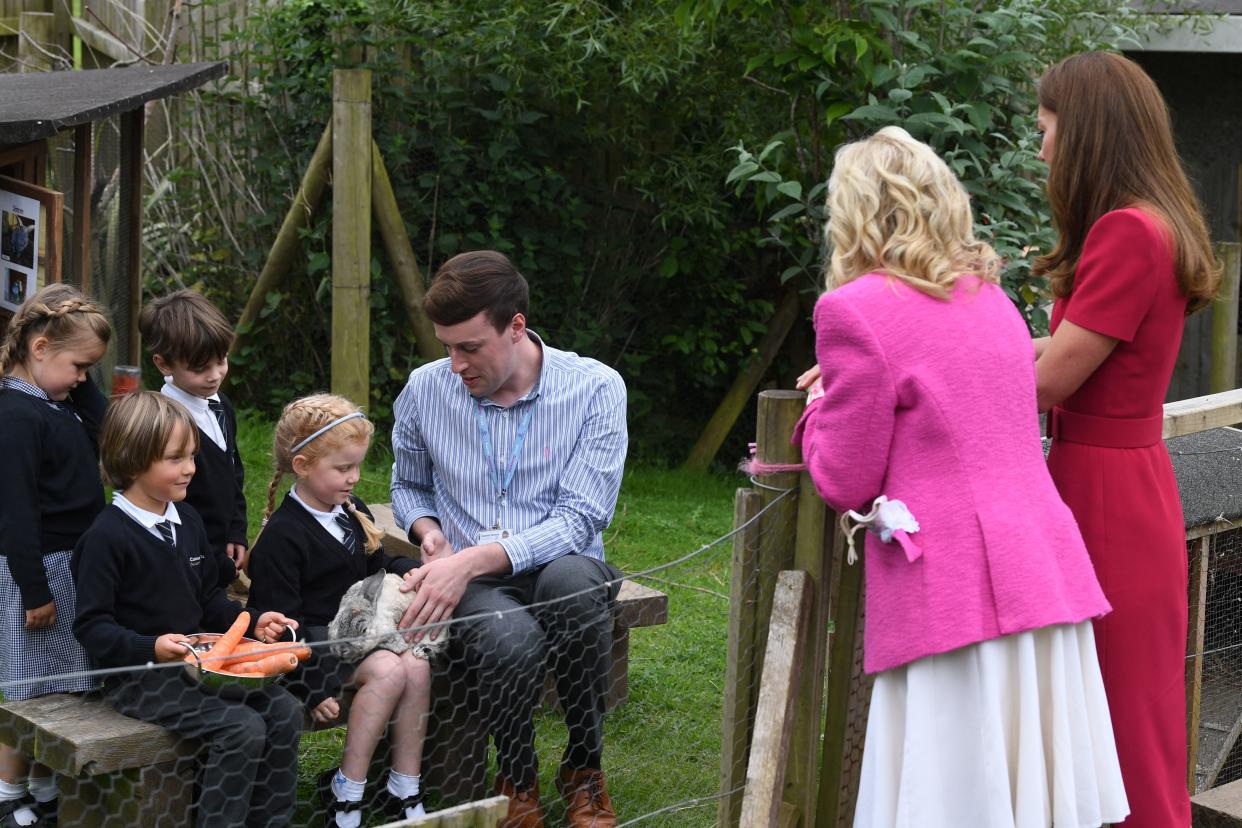 Britain's Catherine, Duchess of Cambridge and US First Lady Jill Biden chat with children feeding a rabbit during their visit to Connor Downs Academy in Hayle, Cornwall on the sidelines of the G7 summit on June 11, 2021. (Photo by DANIEL LEAL-OLIVAS / POOL / AFP) (Photo by DANIEL LEAL-OLIVAS/POOL/AFP via Getty Images)