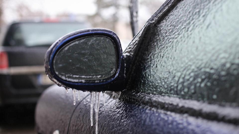 Car frozen side mirror after a freezing rain phenomenon.