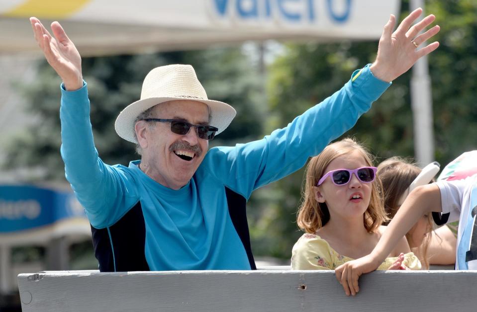 Monroe County Fair Parade Grand Marshal Dean Cousino waves to spectators during Sunday's fair parade.