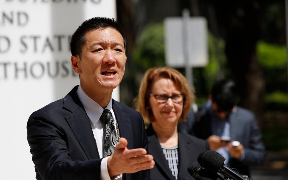 Hawaii Attorney General Douglas Chin answers questions from the press in front of the US District Courthouse in Honolulu, Hawaii - Credit: EPA