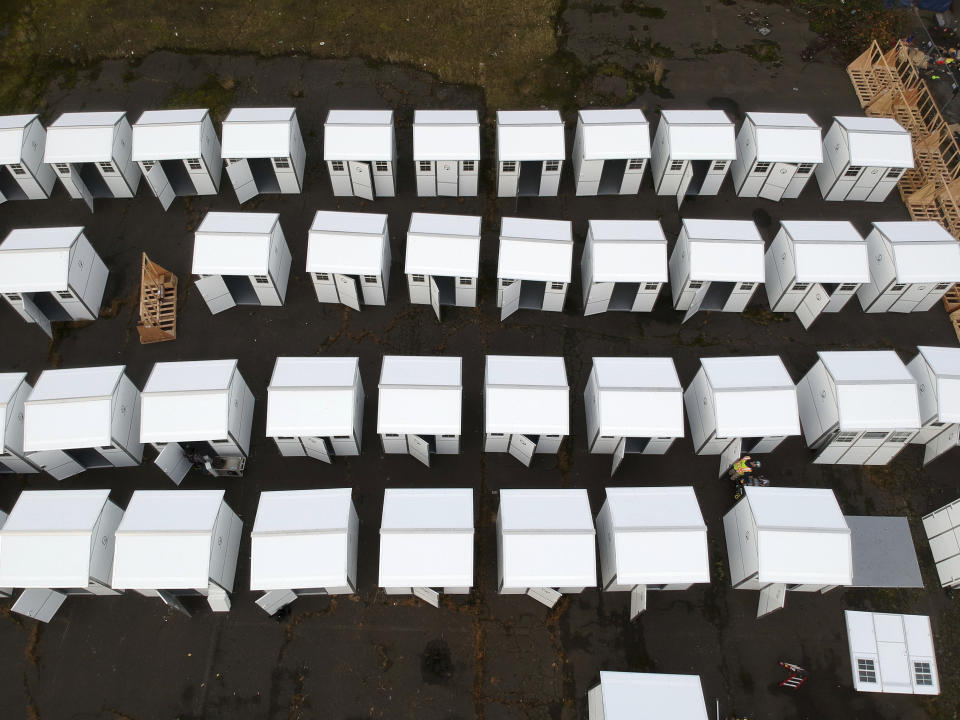 Pods to be used in homeless camps are constructed in Portland, Ore., Tuesday, Dec. 8, 2020. The pandemic has caught homeless service providers in a crosscurrent: demand is high, but their ability to provide services are constricted. Shelter operators who already cut capacity by half to meet social distance requirements face new stresses with winter looming. Coming in from the cold can now mean a night in a warehouse, an old Greyhound bus station, schools or an old jail. (AP Photo/Craig Mitchelldyer)