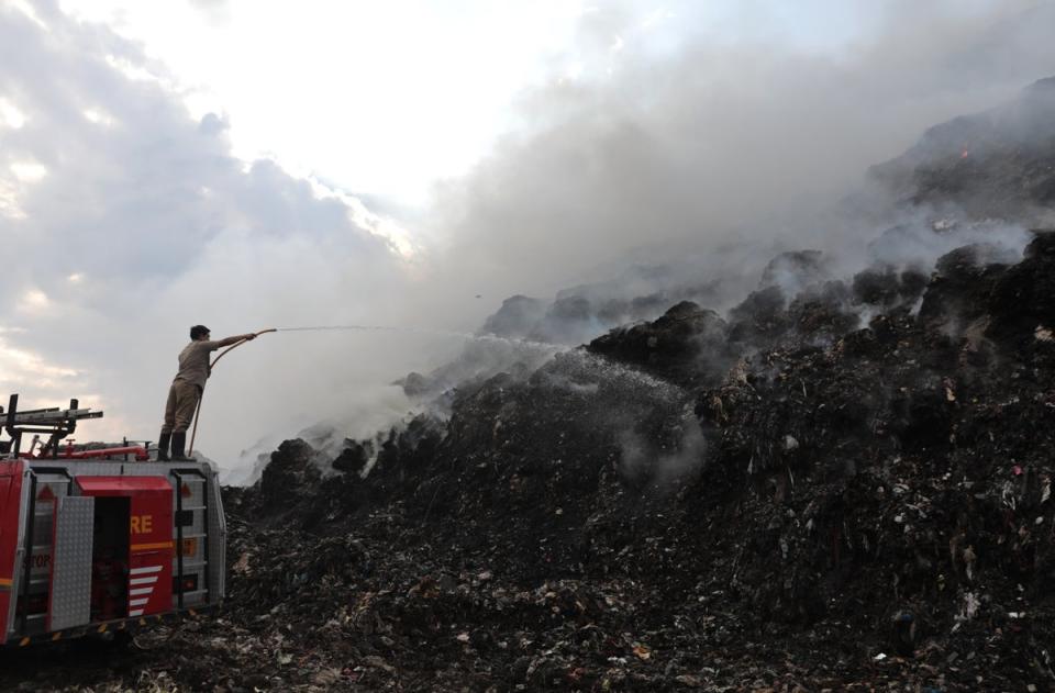 Indian firefighters work to extinguish the fire at the Ghazipur landfill (EPA)