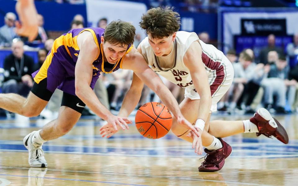 Lyon County's Travis Perry (11), left, and Ashland Blazer's Asher Adkins (5) battle for a loose ball in the fourth quarter at the first round of the 2024 UK Healthcare KHSAA Boys' Sweet 16 in Lexington. March 20, 2024