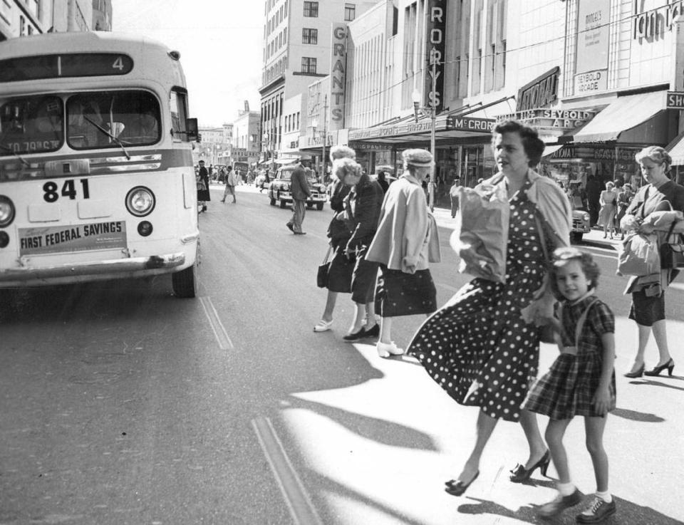 Pedestrians near a county bus on Flagler Street in 1954. Doug Kennedy/Miami Herald File