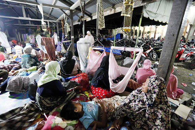 Survivors take rest at the evacuation center in Aceh. Source: AP