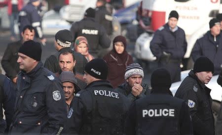 Migrants are seen in front of Bulgarian police after clashes inside a refugee center in the town of Harmanli, Bulgaria, November 25, 2016. REUTERS/Dimitar Kyosemarliev