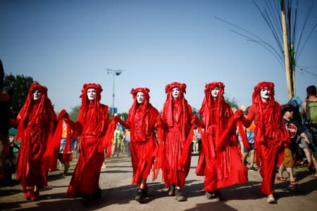 Protestors affiliated with Extinction Rebellion take part in a procession during Glastonbury Festival at Worthy farm in Somerset