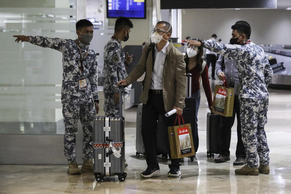 Foreign passengers arrive at Manila's International Airport, Philippines Thursday, Feb. 10, 2022. The Philippines lifted a nearly 2-year ban on foreign travelers Thursday in a lifesaving boost for its tourism and related industries as an omicron-fueled surge eases. (AP Photo/Basilio Sepe)