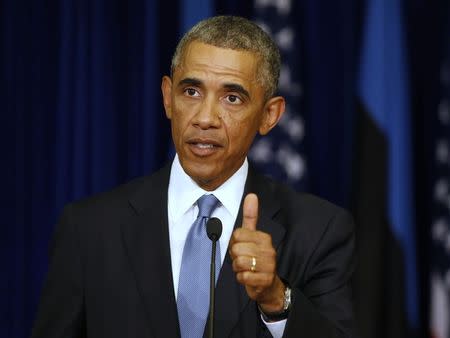 U.S. President Barack Obama gestures during a joint news conference with his Estonian counterpart Toomas Hendrik Ilves, at the Bank of Estonia in Tallinn September 3, 2014. REUTERS/Larry Downing