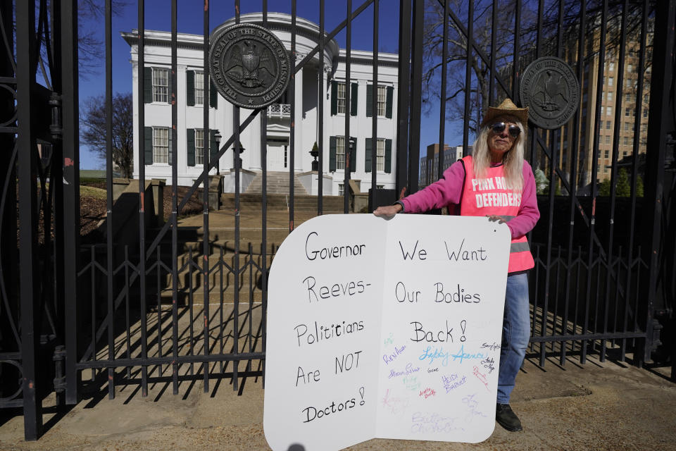 Derenda Hancock, co-director of the Jackson Women's Health Organization clinic patient escorts, better known as the Pink House defenders, stands before the Mississippi Governor's Mansion in Jackson, Friday, Jan. 20, 2023. A small group of abortion rights advocates demonstrated at the building's gates, countering the national March For Life gatherings, while carrying signs calling for abortion rights. A state law banning most abortions, went into effect July 7, 2022. (AP Photo/Rogelio V. Solis)