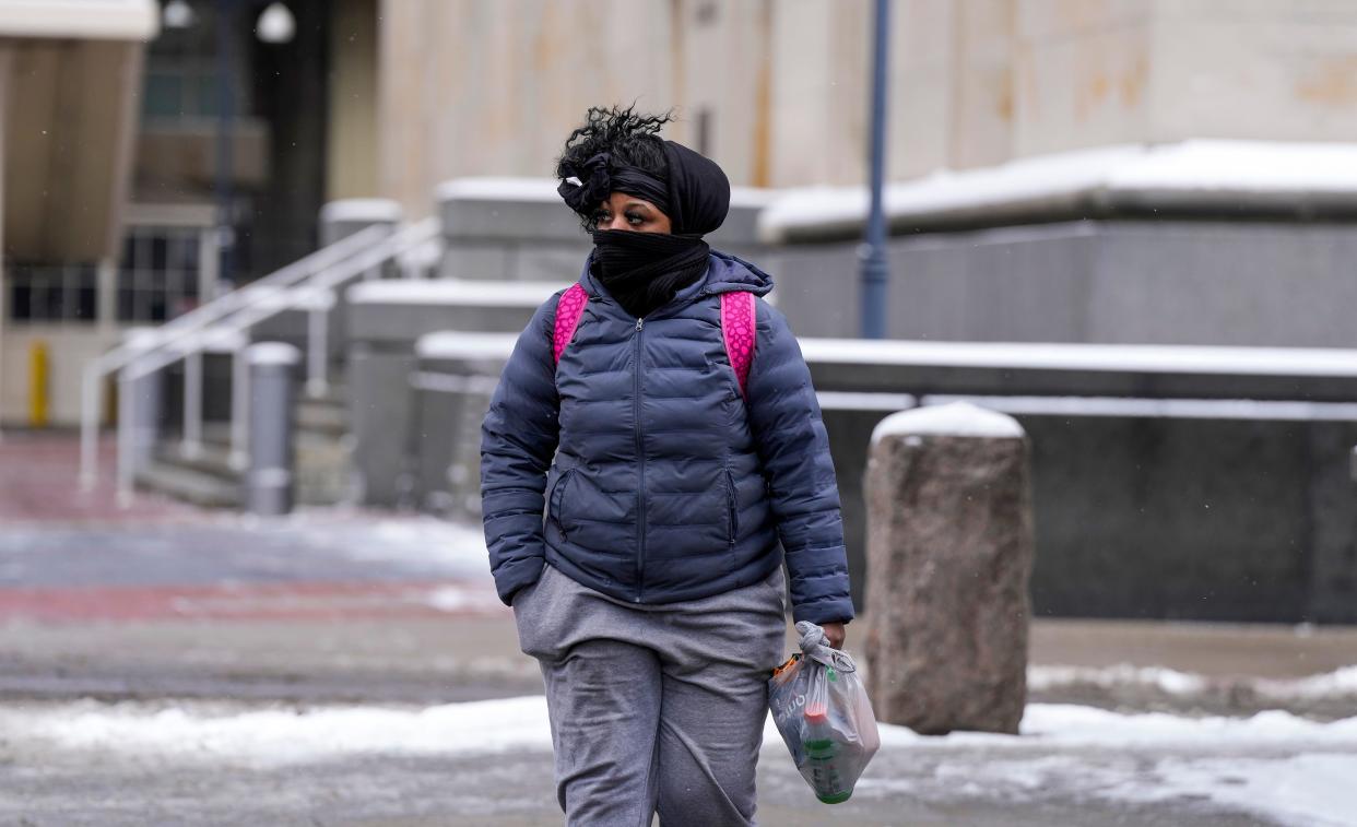 Jazmine Dockery crosses Fifth Street in downtown Cincinnati as she walks to work Friday, January 19, 2024.