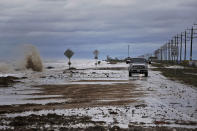 <p>Vehicles navigate past waves and debris washing over State Highway 87 as Tropical Storm Cindy approaches Wednesday, June 21, 2017, in High Island, Texas. (Photo: Michael Ciaglo/Houston Chronicle via AP) </p>