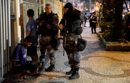 Police officers arrest a suspected drug dealer after a shootout during a police operation at Copacabana neighborhood near the Pavao-Pavaozinho slum in Rio de Janeiro, Brazil, October 10, 2016. REUTERS/Ricardo Moraes