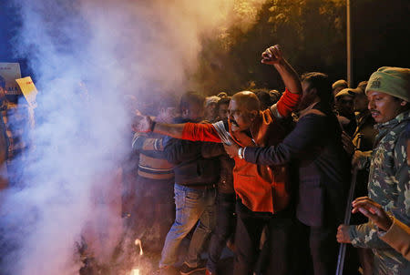 Protesters scuffle with police during a protest against state government