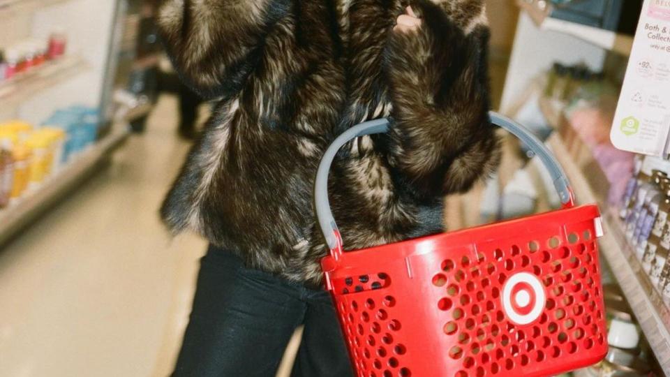 Kourtney Kardashian wears a fur coat, black sunglasses and a cap to shop in Target