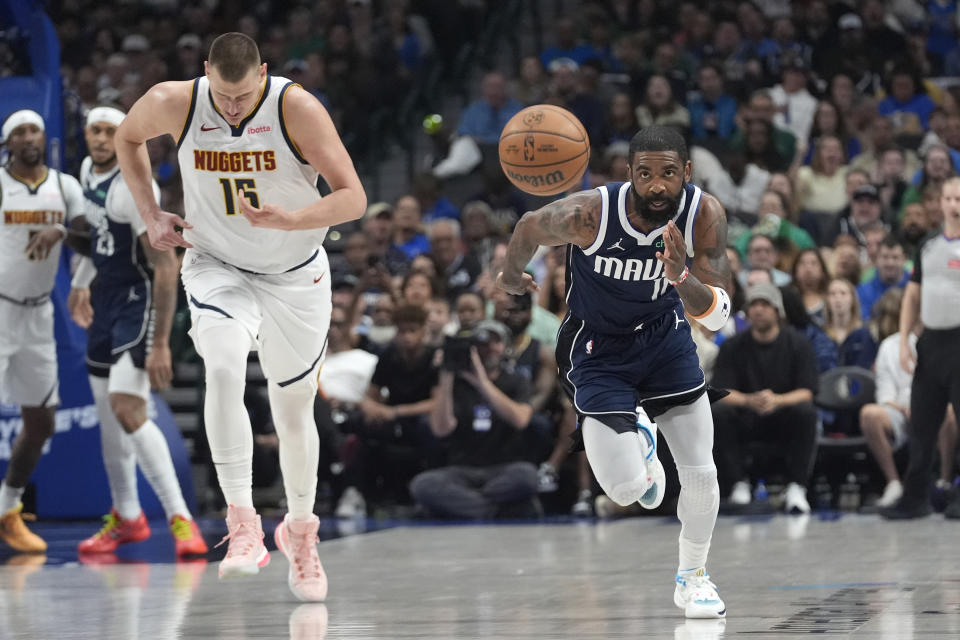 Dallas Mavericks guard Kyrie Irving (11) chases the ball against Denver Nuggets center Nikola Jokic (15) during the first half of an NBA basketball game in Dallas, Sunday, March 17, 2024. (AP Photo/LM Otero)