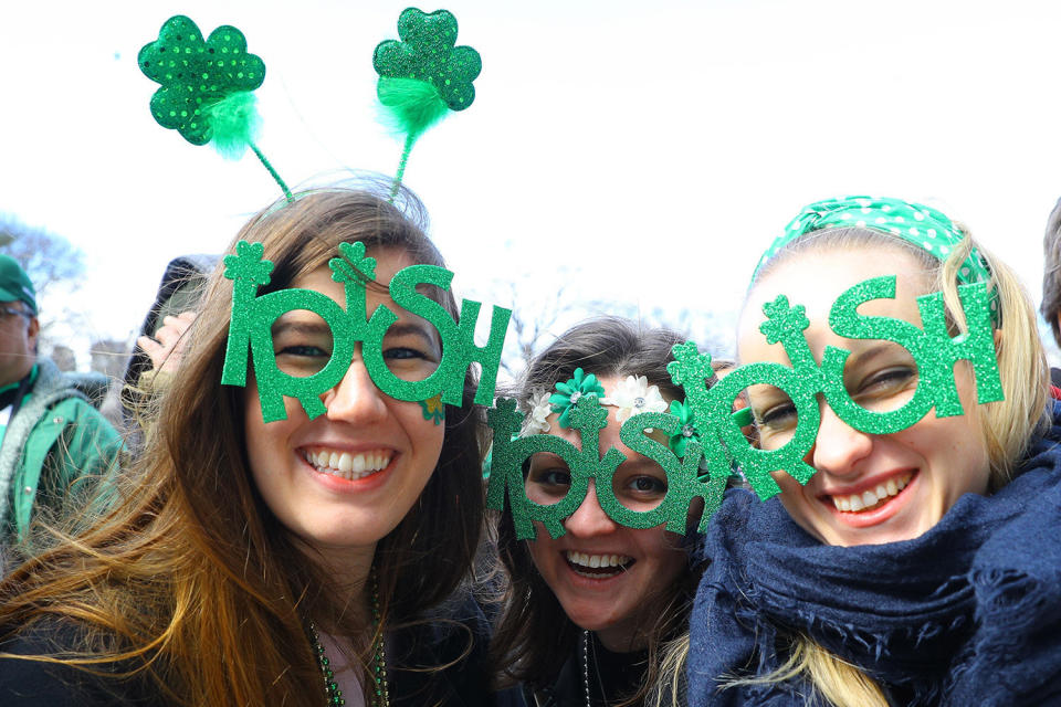 Three women pose for a photo wearing festive eyewear during the St. Patrick's Day Parade, March 16, 2019, in New York. (Photo: Gordon Donovan/Yahoo News) 