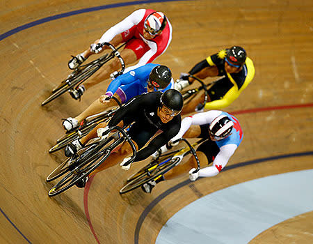 Sam Webster of New Zealand leads the group through the final bend in the Men's Keirin qualifying at the Sir Chris Hoy Velodrome.