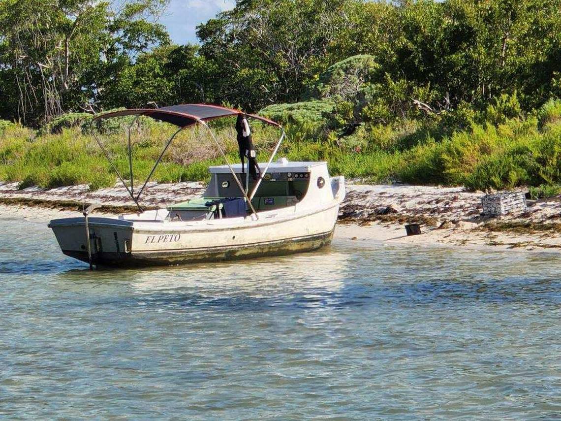 A wooden Cuban fishing vessel is beached on the sand of the Marquesas Keys Sunday morning, July 10, 2022. Nine people from Cuba, who the Border Patrol said migrated on the boat, were taken into custody.
