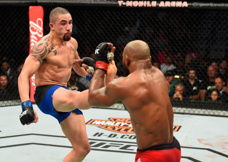 Robert Whittaker (L) and Yoel Romero trade blows during their UFC 213 title fight. (Getty)