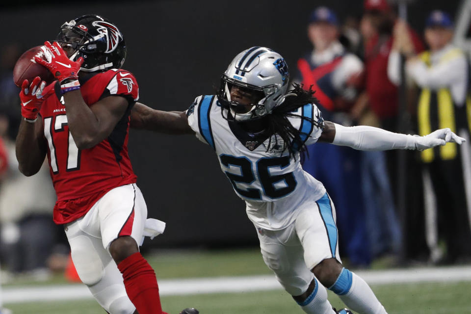 Atlanta Falcons wide receiver Olamide Zaccheaus (17) makes a catch against Carolina Panthers cornerback Donte Jackson (26) during the second half of an NFL football game, Sunday, Dec. 8, 2019, in Atlanta. ran for a touchdown on the play. Zaccheaus(AP Photo/John Bazemore)