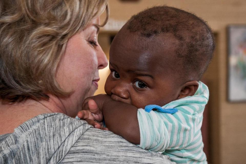 Successful operation: Nancy Swabb holds 10-month old Dominique five days after surgery (REUTERS)