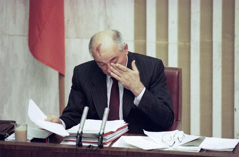 FILE - Soviet President Mikhail Gorbachev rubs his eyes, during the special session of the Supreme Soviet in Moscow, Russia, Aug. 27, 1991. The leaders of Russia, Ukraine and Belarus in early December signed an accord stating the Soviet Union had ceased to exist. Because other constituent republics hadn't signed, its effect was in legal doubt. But on Dec. 25, Gorbachev resigned as Soviet president and the USSR's flag was lowered at the Kremlin after his announcement. (AP Photo/Alexander Zemlianichenko, File)