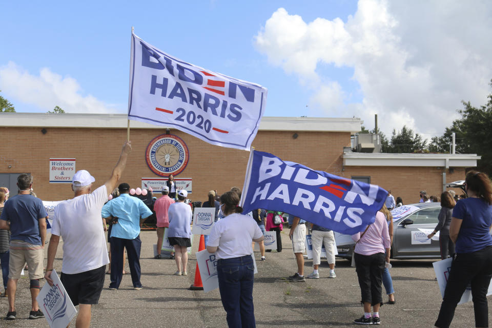 Democrats take part in a rally outside a union hall in Jacksonville, Fla., on Thursday, Oct. 22, 2020, as Florida Agriculture Commissioner Nikki Fried speaks. Democrats hope to make deeper political strides in Jacksonville, which is emerging as the newest battleground in the swing state of Florida. (AP Photo/Bobby Caina Calvan)