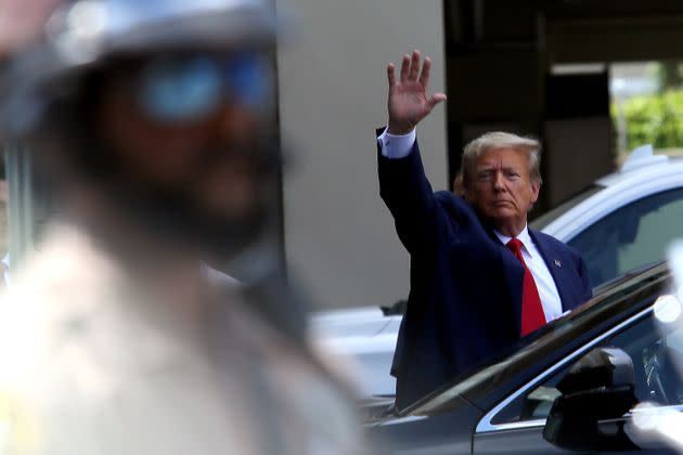 Former President Donald Trump waves as he makes a visit to the Cuban restaurant Versailles in Miami after he pleaded not guilty to 37 federal charges on Tuesday.