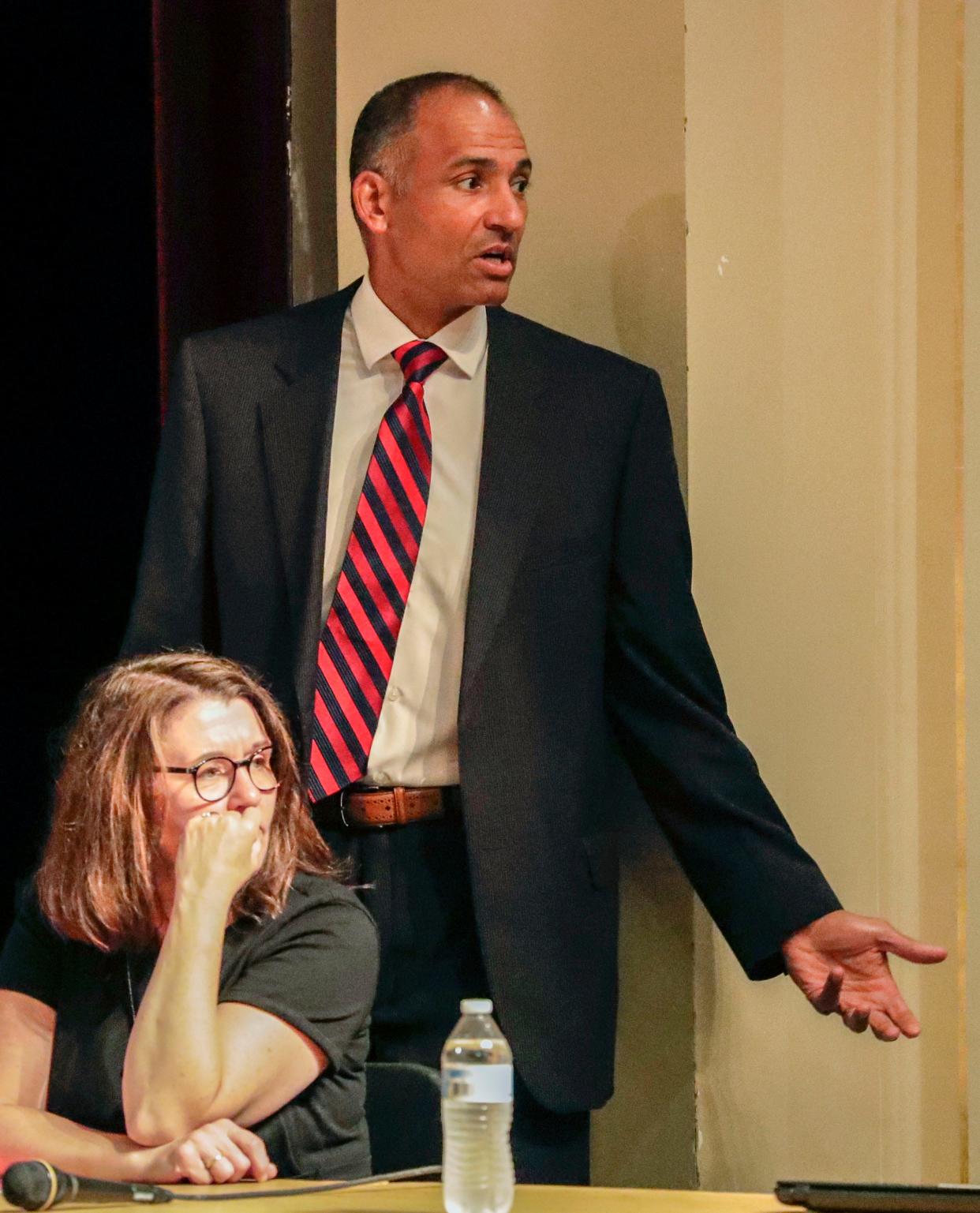 Manitowoc Public Schools Superintendent Mark Holzman talks to a person, off camera, before a school board meeting at Manitowoc Lincoln High School, Tuesday, August 10, 2021, in Manitowoc, Wis.