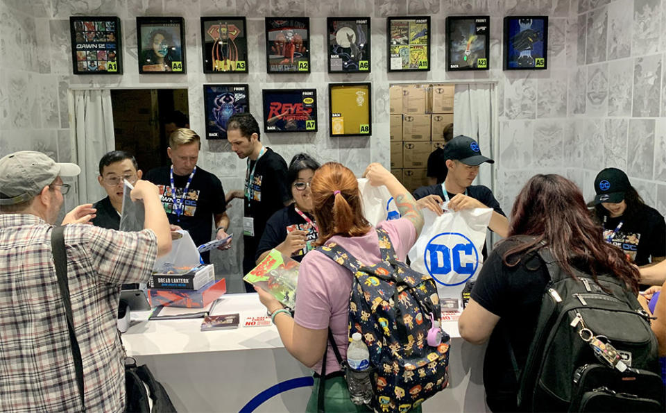 Attendees buying collectibles at the booth.