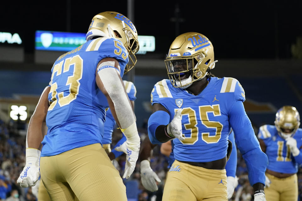 UCLA linebacker Darius Muasau (53) celebrates with linebacker Carl Jones Jr. (35) after a turnover during the first half of an NCAA college football game against Stanford in Pasadena, Calif., Saturday, Oct. 29, 2022. (AP Photo/Ashley Landis)
