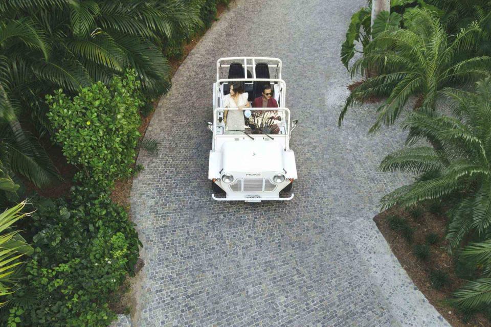 <p>Courtesy of Cheval Blanc St-Barth</p> A couple in a car on the grounds of the Cheval Blanc St.-Barth resort.