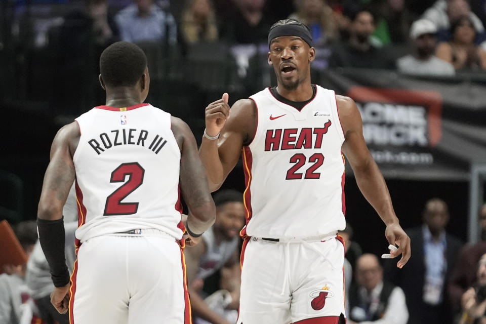 Miami Heat forward Jimmy Butler (22) celebrates after a play with teammate guard Terry Rozier (2) during the first half of an NBA basketball game against the Dallas Mavericks in Dallas, Thursday, March 7, 2024. (AP Photo/LM Otero)