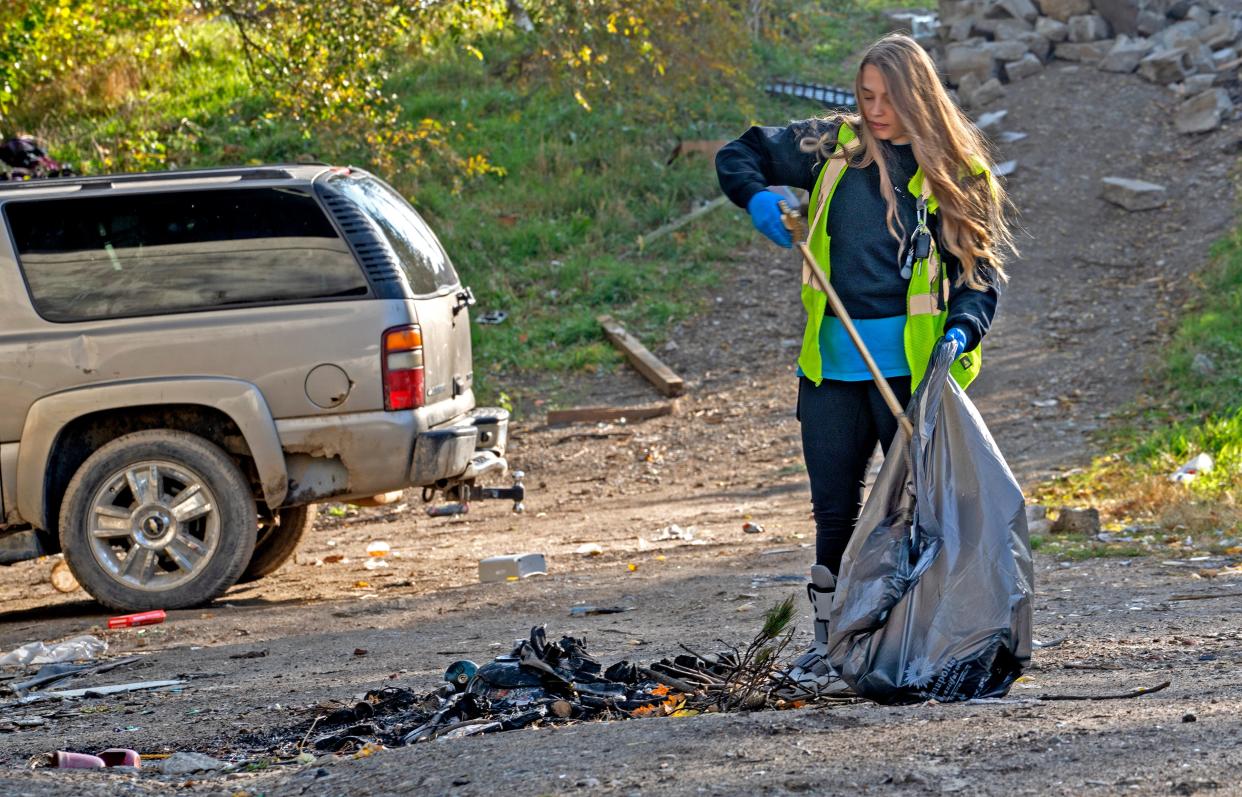 Ryann Davis joins other volunteers on a clean-up project Thursday, Nov. 9, 2023 on the east bank of the White River. Davis is the Manager of Clean Neighborhoods for Keep Indianapolis Beautiful’s Residential Programs.
